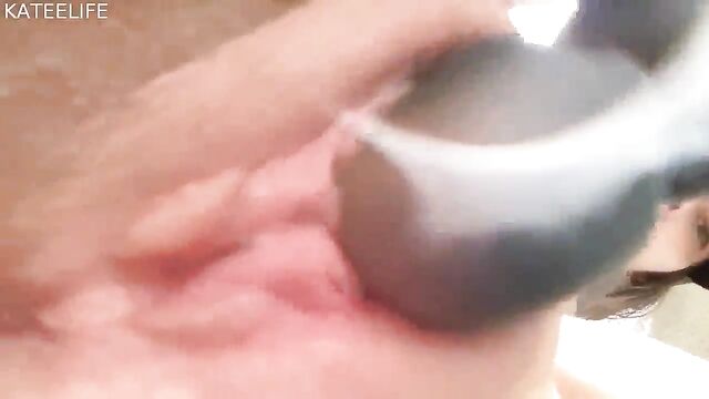 A busty woman takes a shower and caresses her body