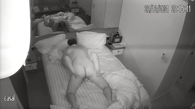 Passionate amateur couple fucking on their bed, captured by a hidden IP cam