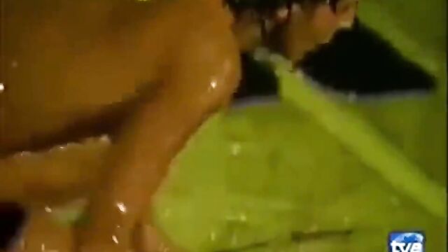 Oiled naked dance of a brunette on the stage