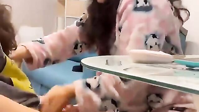 Two hot lesbian sisters are rubbing each other’s pussies and fingering