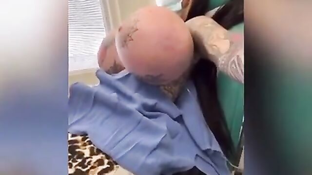 A bimbo with huge fake boobs tries on bras in the bedroom